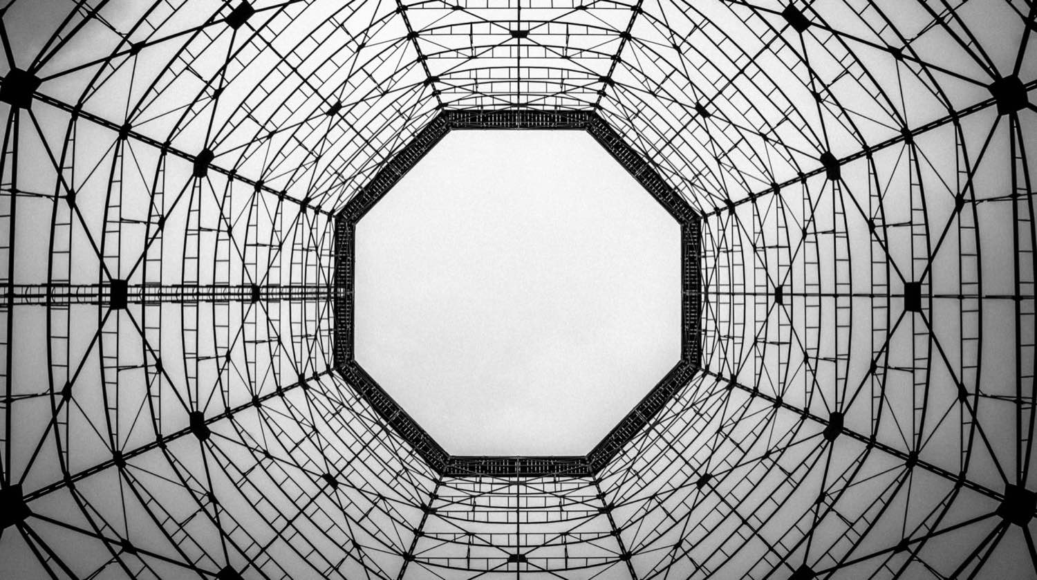 The steel structure of a building roof, seen from below.